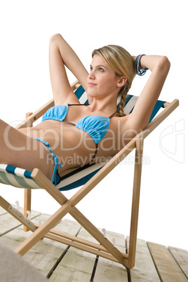 Beach - Young woman in bikini sitting on deck chair