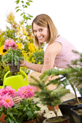 Gardening - Happy woman holding flower pot