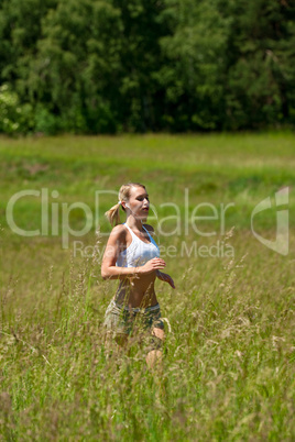 Young woman jogging in a meadow