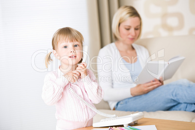 Little girl on phone in living room