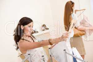 Fashion shopping - Two Happy woman choose sale clothes