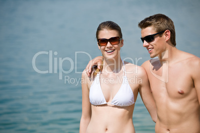 Happy couple in swimwear at sea in summer