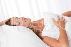 White lounge - Young woman lying in white bed