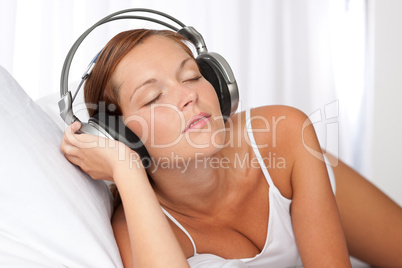 Young woman in white with headphones