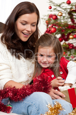 Mother with child opening present