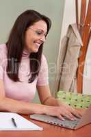 Smiling businesswoman with laptop at office