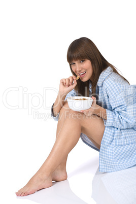 Female teenager eat healthy  cereal for breakfast