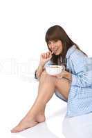 Female teenager eat healthy  cereal for breakfast