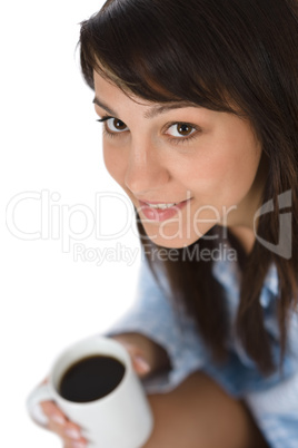 Happy young woman with coffee in pajamas