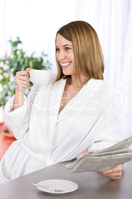 Breakfast - happy woman reading newspaper drink coffee