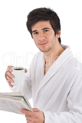 Morning - man in bathrobe with cup of coffee and newspaper