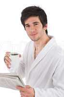 Morning - man in bathrobe with cup of coffee and newspaper