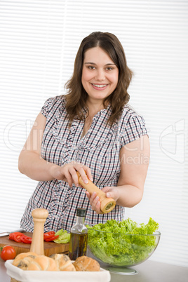Cook - Plus size happy woman preparing salad