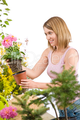 Gardening - Happy woman holding flower pot