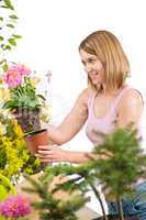 Gardening - Happy woman holding flower pot