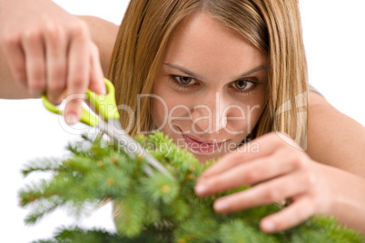 Gardening - woman trimming spruce tree