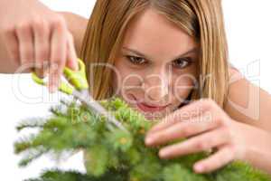 Gardening - woman trimming spruce tree