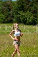 Young woman jogging in a meadow