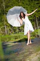 Happy romantic woman with parasol in sunlight