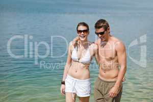 Happy couple in swimwear at sea enjoy sun