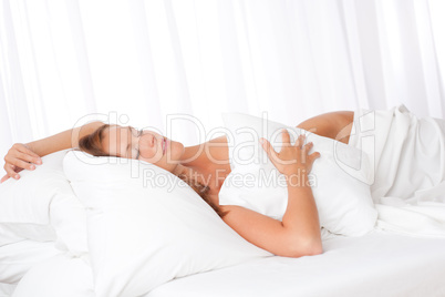 White lounge - Young woman sleeping in bed