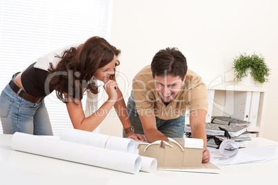 Young man and woman working at architect office