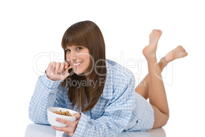 Female teenager eat healthy  cereal for breakfast