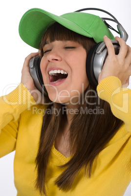 Happy female teenager enjoy music with headphones