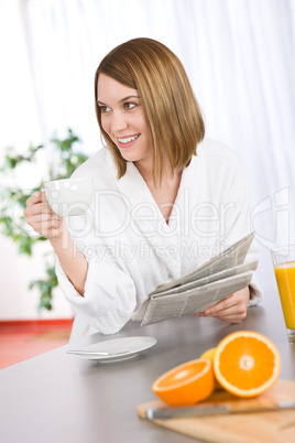 Breakfast - happy woman reading newspaper drink coffee