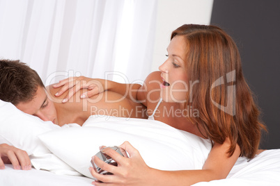 Young woman waking up man