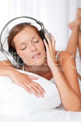 Young woman in white with headphones