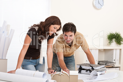 Young man and woman working at architect office