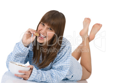 Female teenager eat healthy  cereal for breakfast