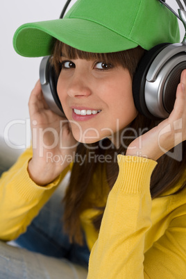 Happy female teenager enjoy music with headphones