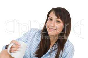 Happy young woman with coffee in pajamas