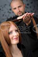 Professional hairdresser with fashion model at luxury salon
