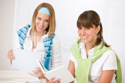 Student at home - two young woman study together