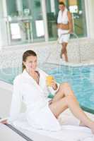 Young woman in bathrobe relax at swimming pool