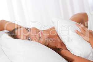 White lounge - Smiling woman lying in bed