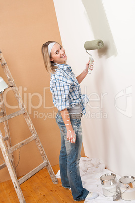 Home improvement: Blond woman painting wall