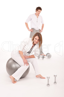 Fitness - Young couple training with weights and ball