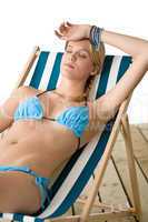 Beach - Young woman in bikini relax on deck chair