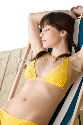 Beach - Beautiful woman sunbathing in bikini on deck chair