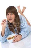 Female teenager eat healthy cereal for breakfast