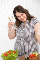 Cook - Plus size woman with white wine and salad