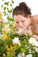 Gardening - Woman smelling blossom flower