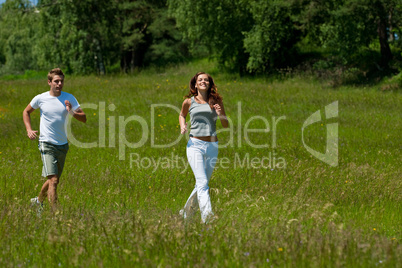 Young couple jogging outdoors in spring nature