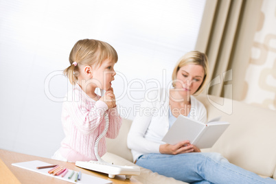 Mother and child - on the phone in living room