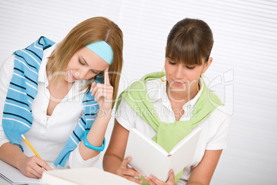 Student at home - two young woman study together