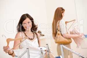 Fashion shopping - Two Happy woman choose sale clothes
